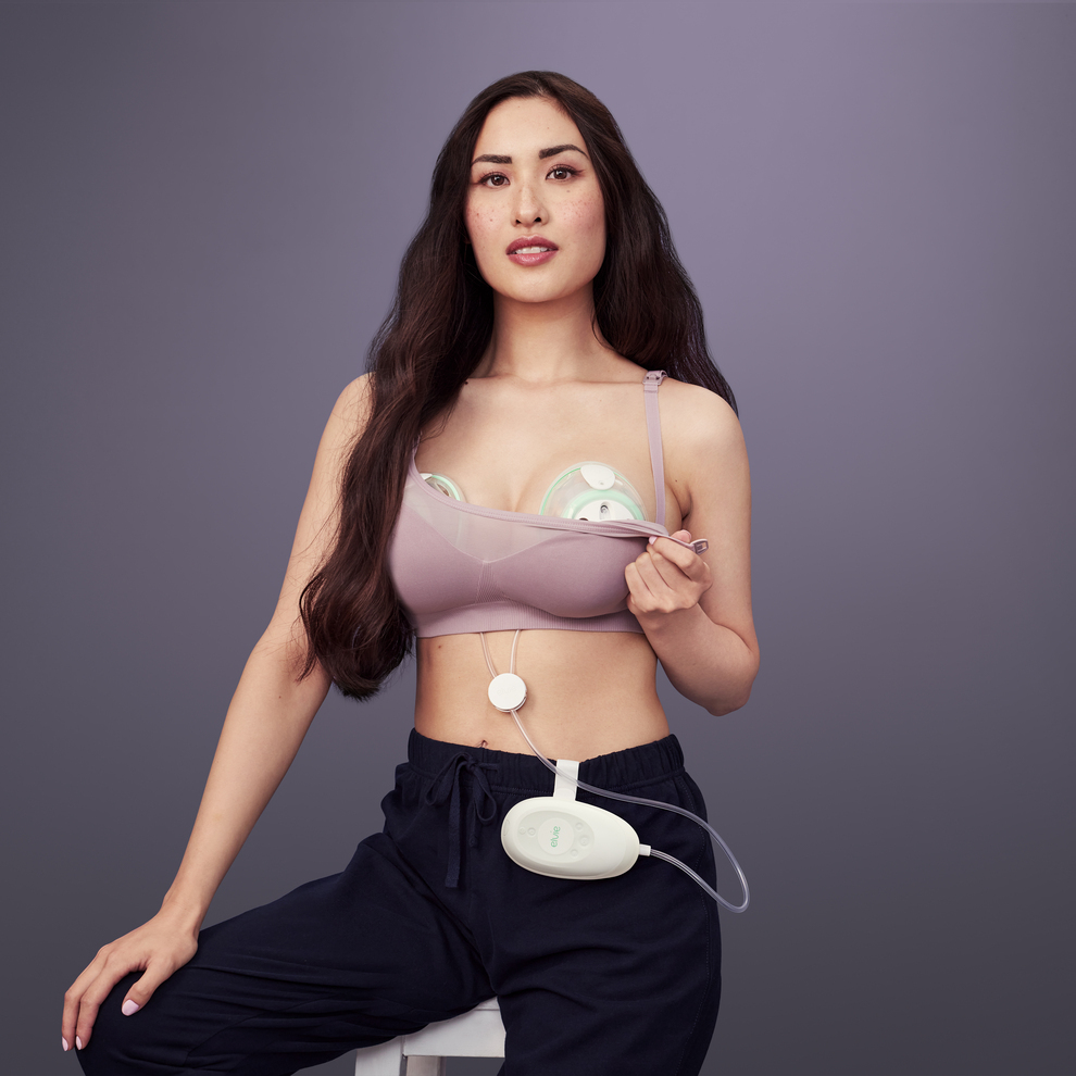 A woman uses an Elvie Stride breast pump under her clothing
